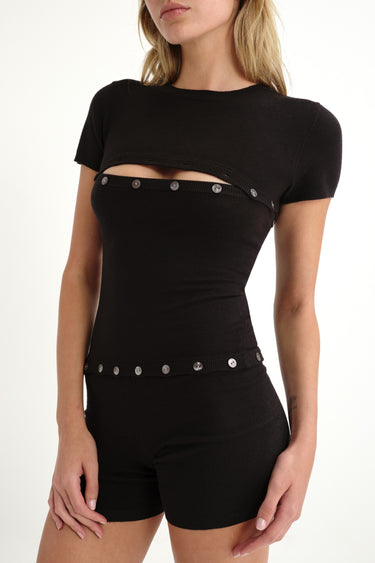 black shortsleeve knit romper with mother of pearl buttons at bust and waist