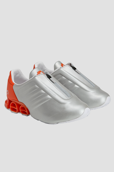 silver and orange adidas shoe with white sole and tongue zipper