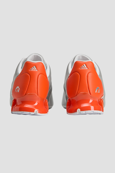 silver and orange adidas shoe with white sole and tongue zipper