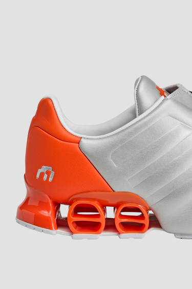 silver and orange adidas shoe with white sole and tongue zipper